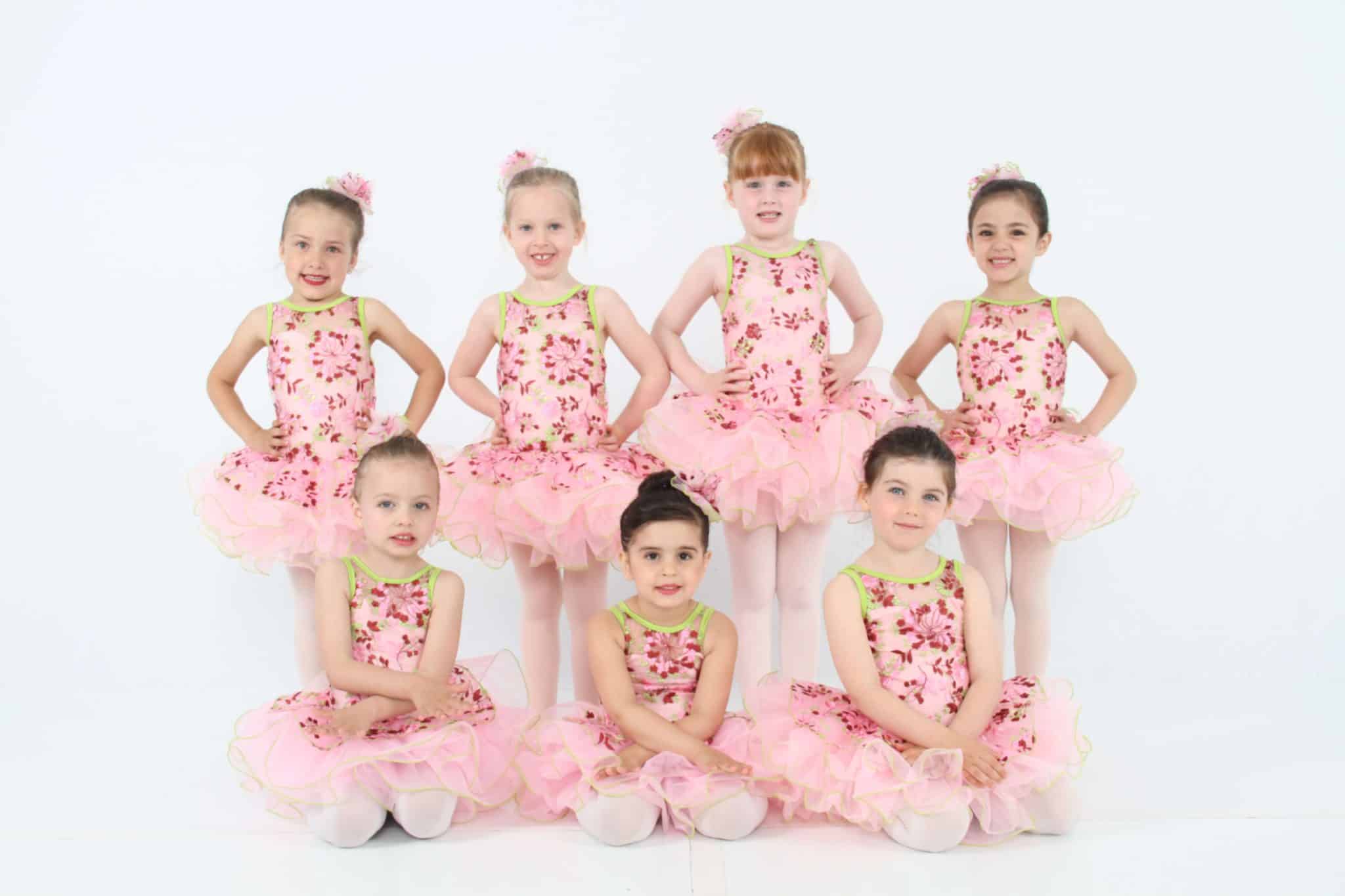 group of toddler ballet dancers in pink ballet costumes
